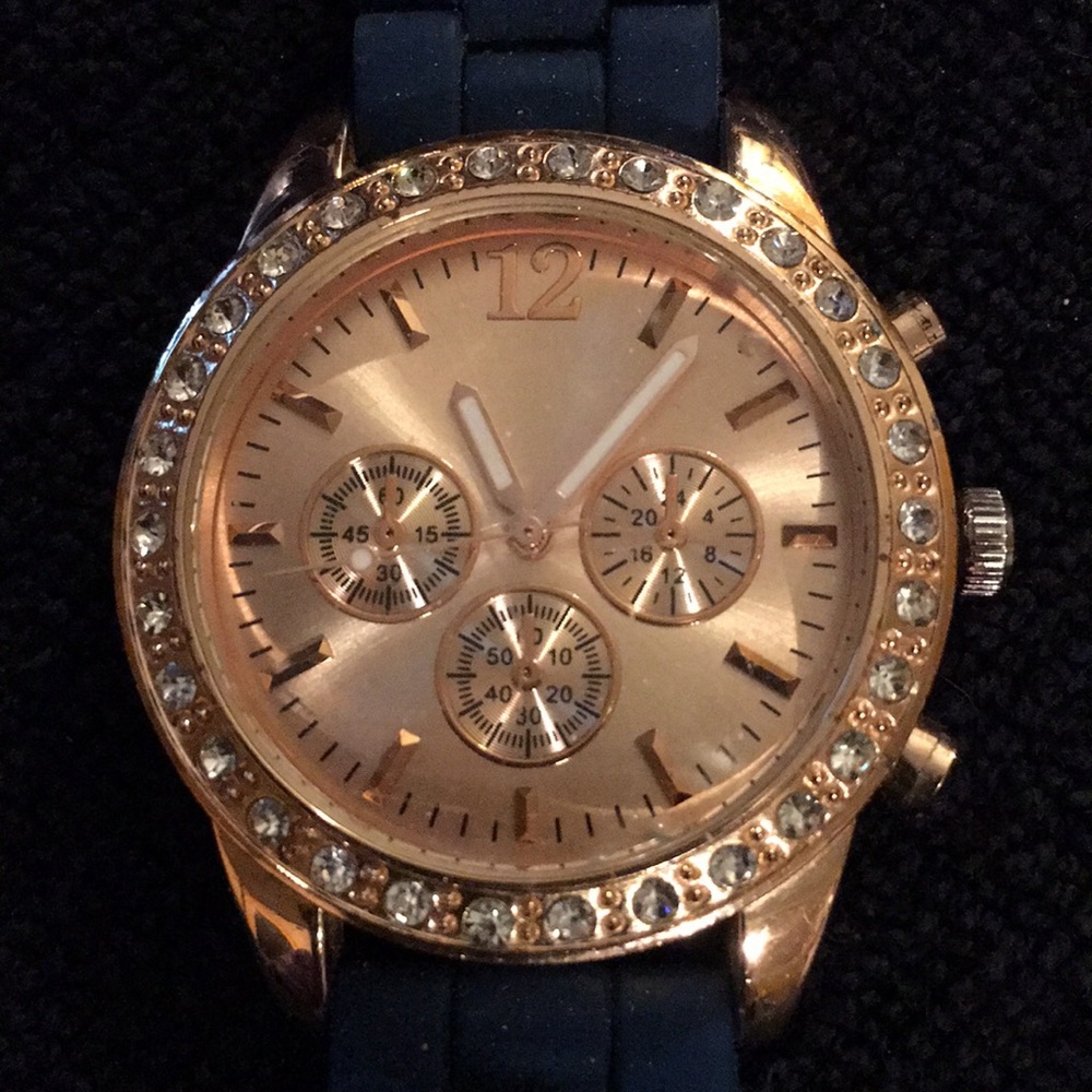 Gold tone watch with blue silicone band